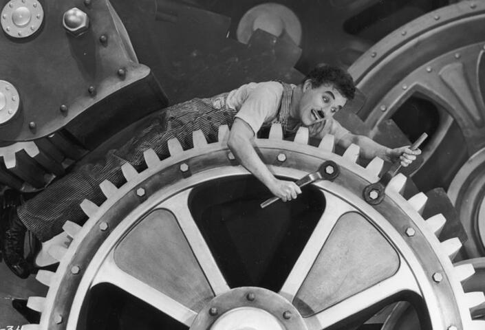Charlie Chaplin on a huge cog in the movie "Modern Times"