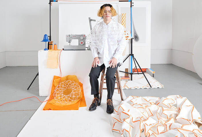 Harvard Horizons Scholar Noah Toyonaga surrounded by some of the structures he's created in his exploration of the scissors motif